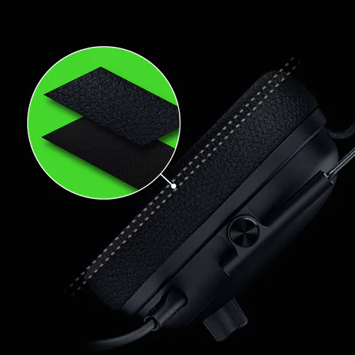 A macro shot of the Razer Blackshark V3 Pro's earcup, with a magnified view showing the layers of breathable fabric and plush memory foam.