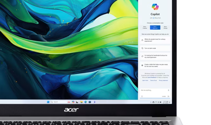 Front view of the Acer Aspire Go 15 laptop showing the Windows 11 desktop and Copilot sidebar.