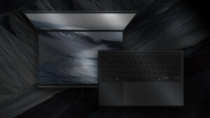 ASUS Zenbook Duo (2026) displaying a dark wallpaper on dual OLED screens with the detached keyboard, set against a dark textured background.